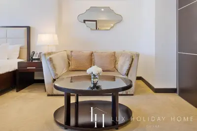 a living room with a couch and a table at LUX The JW Marina Studio 3 in Dubai