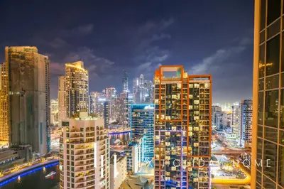 a city skyline at night with tall buildings at LUX The JW Marina Studio 3 in Dubai
