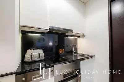 a kitchen with a sink and a toaster on a counter at LUX The JW Marina Studio 3 in Dubai