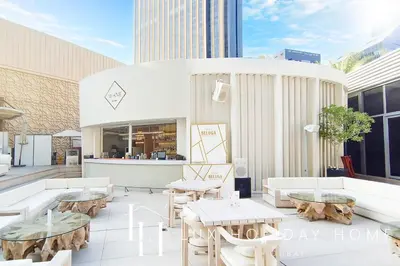 a patio with tables and couches in a building at LUX The JW Marina Studio 3 in Dubai