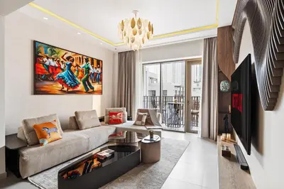 a living room with a couch and a chandelier at Pool side view at Dubai Creek Harbour by DuStay in Dubai