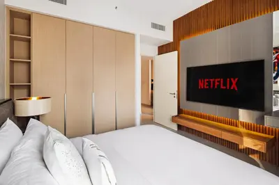 a bedroom with a bed and a television on the wall at Pool side view at Dubai Creek Harbour by DuStay in Dubai
