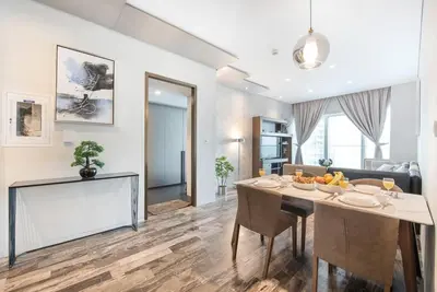 a kitchen and living room with a table and chairs at FIRST CLASS 1BR Amazing Marina Views in Dubai