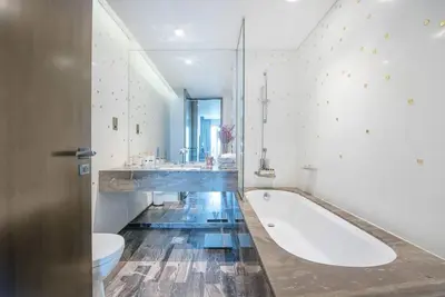 a large bathroom with a tub and a toilet at FIRST CLASS 1BR Amazing Marina Views in Dubai