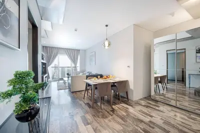 a kitchen and living room with a table and chairs at FIRST CLASS 1BR Amazing Marina Views in Dubai