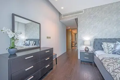 a bedroom with a bed and a dresser with a mirror at FIRST CLASS 1BR Amazing Marina Views in Dubai