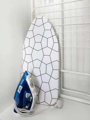 a bathroom with a white hexagon tile wall at Dar Mama - Cozy modern apartment in Golf Vita, Dubai in Dubai
