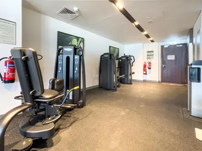 a gym with a row of treadmills and machines at New! PS5! Burj Khalifa view & Infinity Pool in Dubai