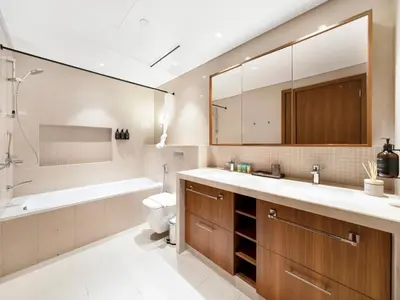 a bathroom with a sink and a tub and a toilet at New! PS5! Burj Khalifa view & Infinity Pool in Dubai