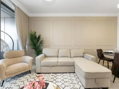 a living room with a couch and chairs at New! PS5! Burj Khalifa view & Infinity Pool in Dubai