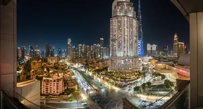 a city skyline at night with a tall building at New! PS5! Burj Khalifa view & Infinity Pool in Dubai