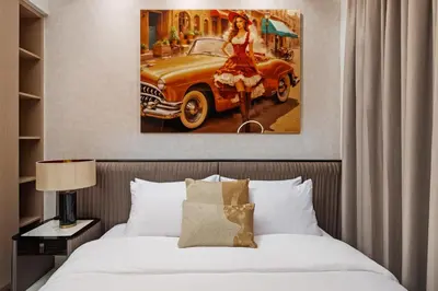 a painting of a woman in a red dress and an old car at Spacious Apartment - Dubai Creek Harbour by DuStay in Dubai