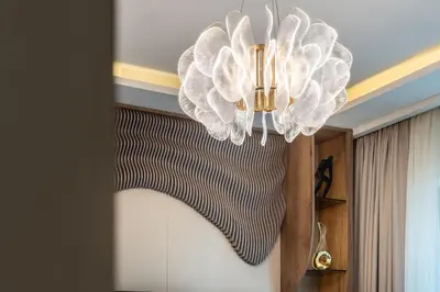 a chandelier hanging from a ceiling in a room at Modern Apartment in Dubai Creek Harbour By DuStay in Dubai