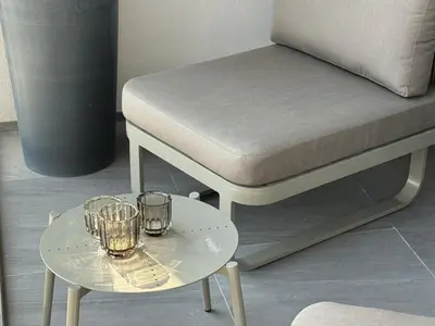 a bed and a table with two glasses on it at Chic and Bright Studio in Meydan in Dubai