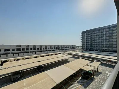 a view of a building with benches in front of it at Chic and Bright Studio in Meydan in Dubai