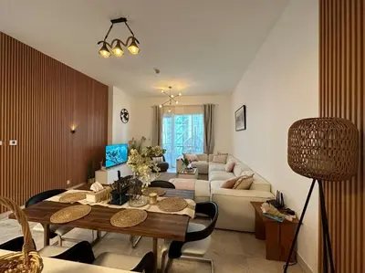 a living room with a couch and a table at 2 Bedrooms Apartment with Marina Views in Dubai