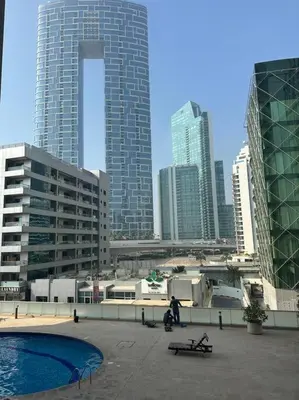 a city skyline with tall buildings and a pool at 2 Bedrooms Apartment with Marina Views in Dubai