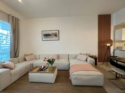 a living room with a couch and a table at 2 Bedrooms Apartment with Marina Views in Dubai