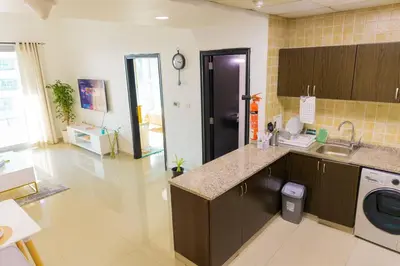 a large kitchen with a sink and a dishwasher at Himalaya Holiday Homes 1 BHK Apartment in Dubai