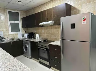 a kitchen with a refrigerator and a dishwasher at Himalaya Holiday Homes 1BHK - Dubai Marina in Dubai