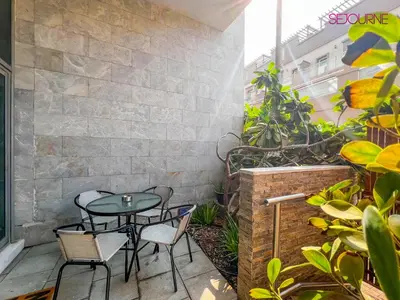 a patio with a table and chairs on a patio at Modern studio in villa Pera tower JVC in Dubai