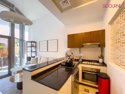 a kitchen with a sink and a stove top oven at Modern studio in villa Pera tower JVC in Dubai