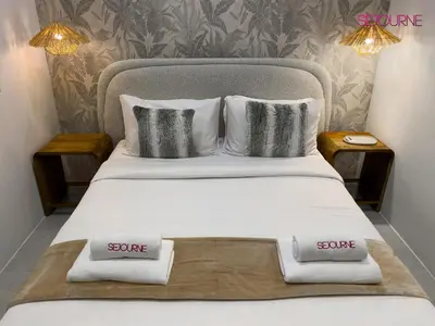 a bedroom with a large bed with two pillows on it at Modern studio in villa Pera tower JVC in Dubai