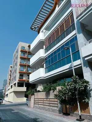 a building on the side of a street at Modern studio in villa Pera tower JVC in Dubai