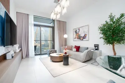 a living room with a couch and a table at Iconic 1BR l Boulevard View l Walk to Dubai Mall in Dubai