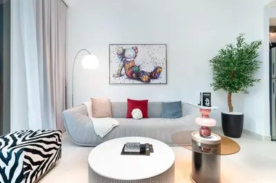 a living room with a couch and a table at Iconic 1BR l Boulevard View l Walk to Dubai Mall in Dubai