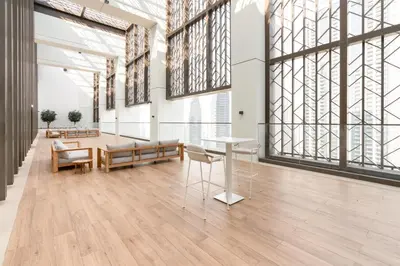a large room with a table and chairs and large windows at Iconic 1BR l Boulevard View l Walk to Dubai Mall in Dubai