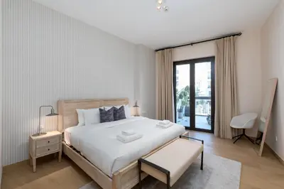 a bedroom with a large white bed and a window at La Cote, Port de La Mer, Jumeirah 1 - Mint Stay in Dubai