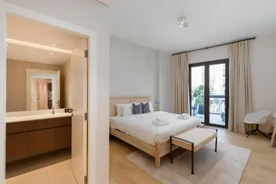 a hotel room with a bed and a bath tub at La Cote, Port de La Mer, Jumeirah 1 - Mint Stay in Dubai