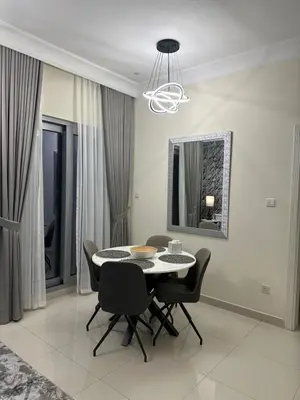 a dining room with a table and chairs and a mirror at Royal Apartments Dubai Mall in Dubai