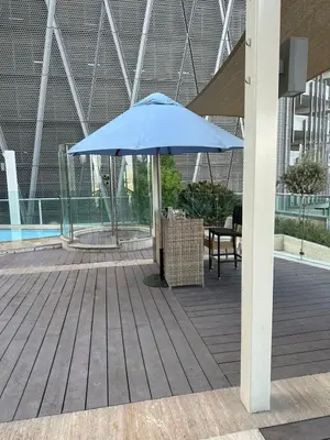 a blue umbrella sitting on top of a wooden deck at Royal Apartments Dubai Mall in Dubai