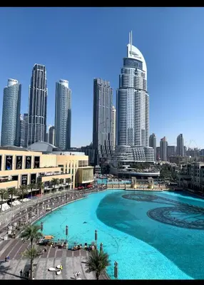 a large pool in front of a city with tall buildings at Royal Apartments Dubai Mall in Dubai