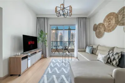 a living room with a couch and a tv at GuestReady - Splendid Stay in Dubai Marina in Dubai