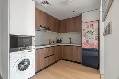 a kitchen with a washing machine and a washer at GuestReady - Splendid Stay in Dubai Marina in Dubai
