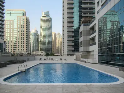 a large swimming pool in a city with tall buildings at GuestReady - Splendid Stay in Dubai Marina in Dubai