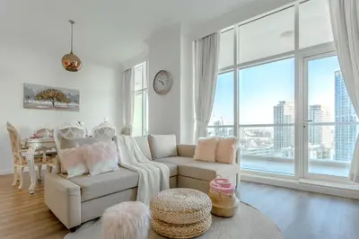 a living room with a couch and a table at Elegant 2 Bedroom Apartment in Dubai Marina- Just 1 Min walk from JBR Beach in Dubai