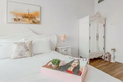 a white bed with a box with a picture of a woman on it at Elegant 2 Bedroom Apartment in Dubai Marina- Just 1 Min walk from JBR Beach in Dubai