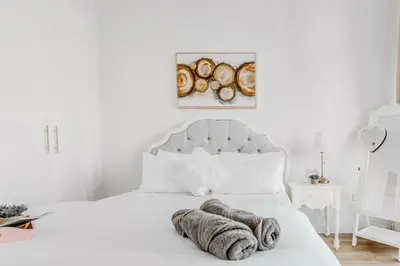 a white bedroom with a white bed with a white headboard at Elegant 2 Bedroom Apartment in Dubai Marina- Just 1 Min walk from JBR Beach in Dubai