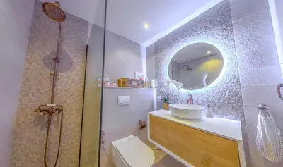 a bathroom with a shower and a toilet and a sink at Elegant 2 Bedroom Apartment in Dubai Marina- Just 1 Min walk from JBR Beach in Dubai
