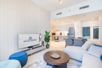 a living room with a couch and a tv at Minimal 1BR Minutes away from the Dubai Mall in Dubai
