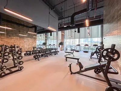a gym with several rows of exercise equipment in a room at Minimal 1BR Minutes away from the Dubai Mall in Dubai