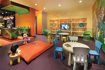 a kids room with a bed and a table and chairs at Cozy Hideaway-Damac Cour Jardin near Dubai Mall in Dubai