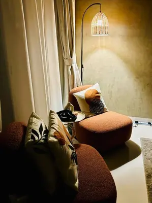 a living room with a couch and a lamp at Cozy Hideaway-Damac Cour Jardin near Dubai Mall in Dubai