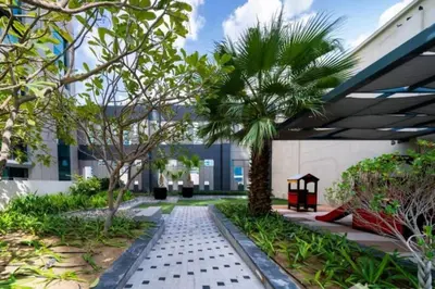a courtyard with a palm tree in a building at Cozy Hideaway-Damac Cour Jardin near Dubai Mall in Dubai