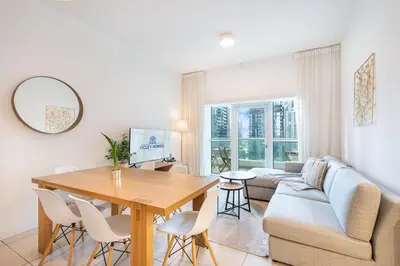 a living room with a table and a couch at Beautiful Home at the Heart of Marina in Dubai