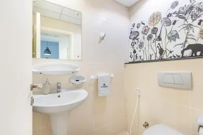 a bathroom with a sink and a toilet and a mirror at Beautiful Home at the Heart of Marina in Dubai
